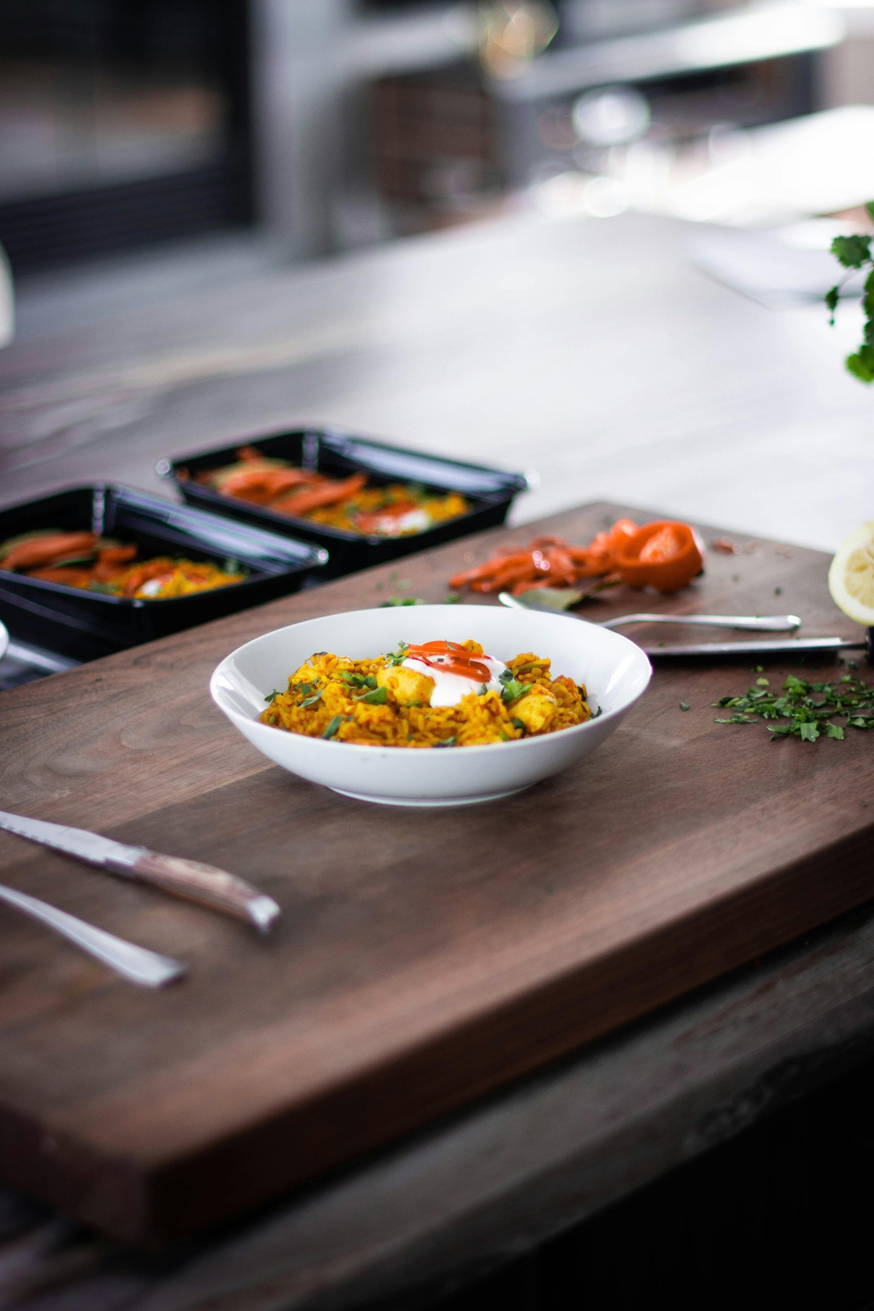 Close-up of a gourmet meal served on a wooden cutting board with vibrant vegetables and herbs.